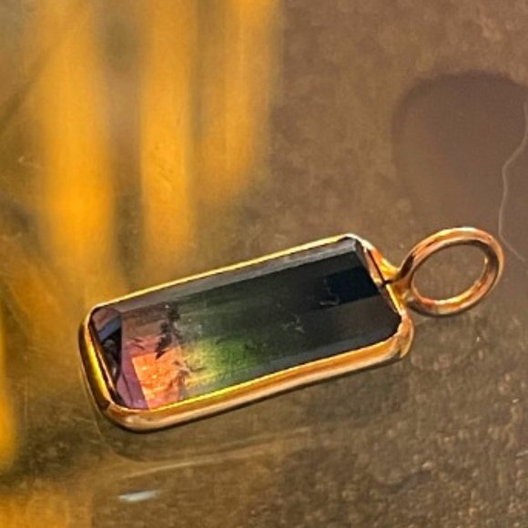 Featuring a gorgeous and vibrant natural tourmaline with an emerald cut